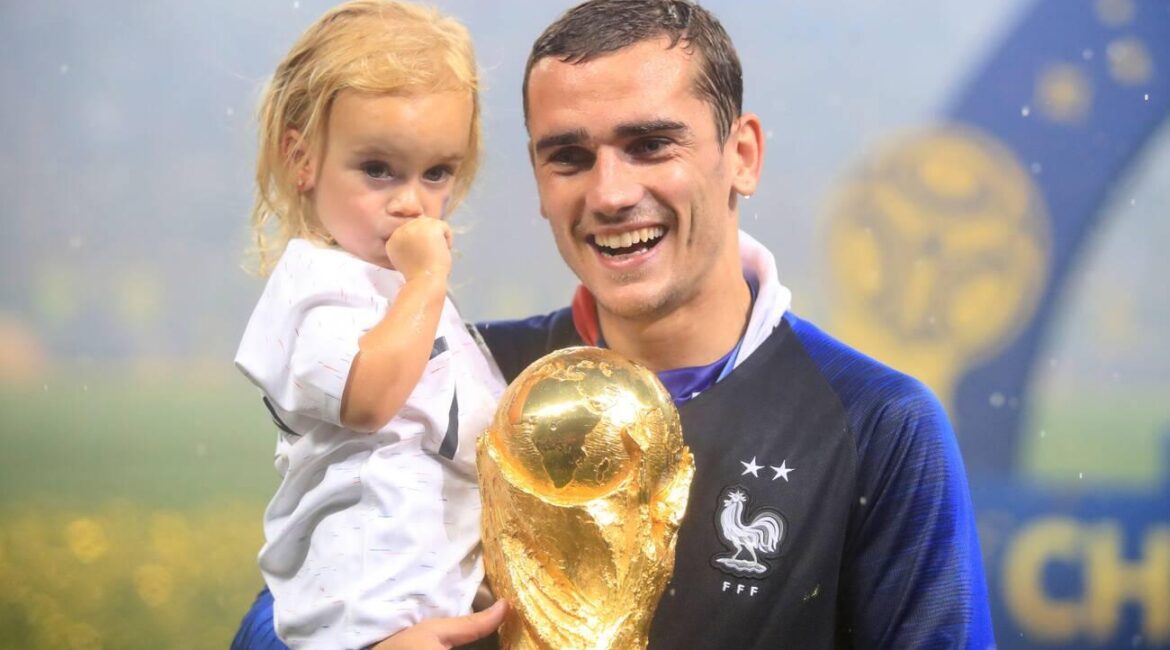 France's Antoine Griezmann celebrates with daughter Mia Griezmann and the trophy after France win the FIFA World Cup 2018