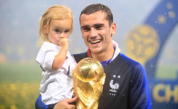 France's Antoine Griezmann celebrates with daughter Mia Griezmann and the trophy after France win the FIFA World Cup 2018